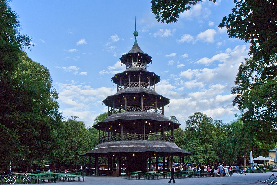 The wooden Chinese Tower and beer garden under trees in the Englischer Garten.